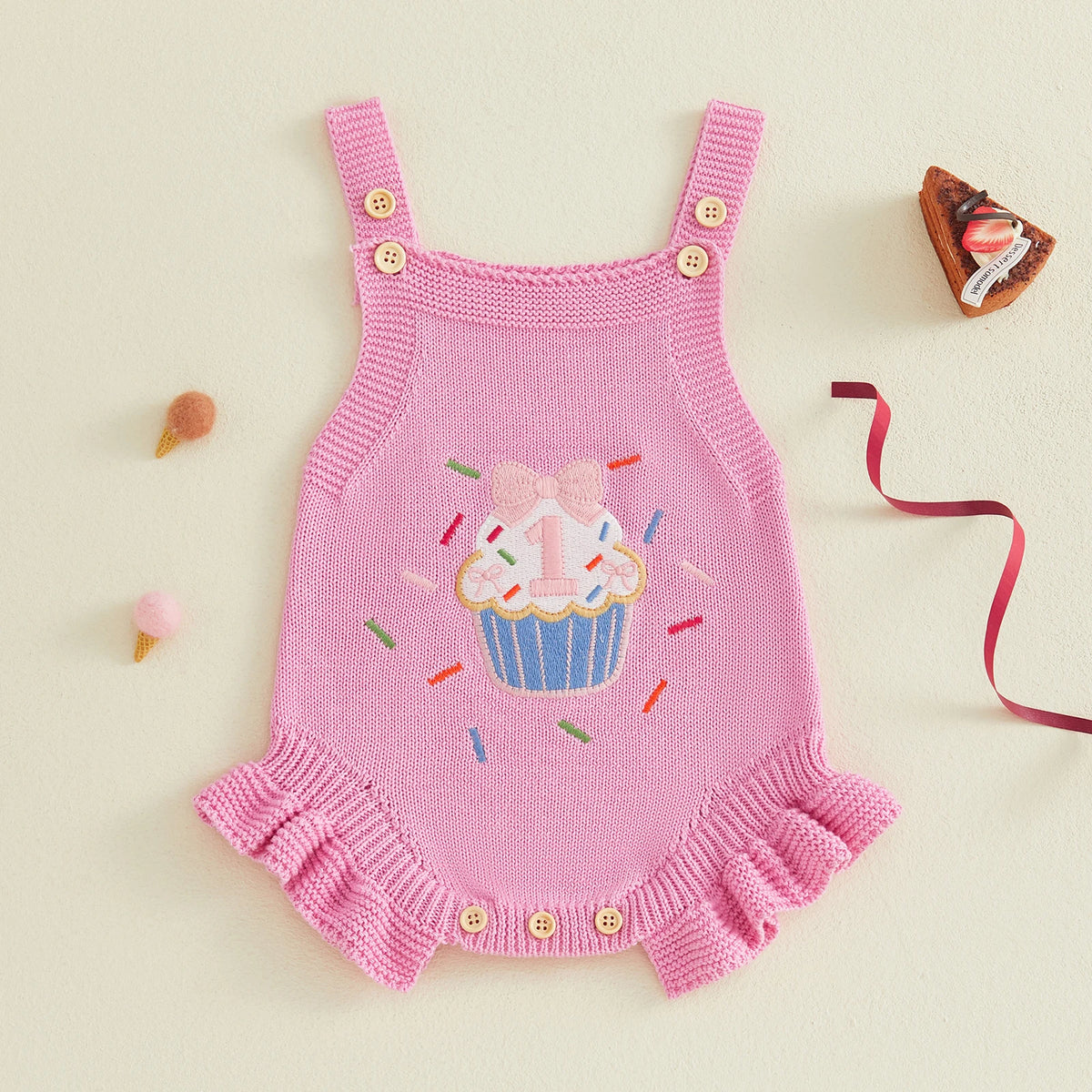 Pink knitted romper overalls for baby girl with cupcake applique and button straps