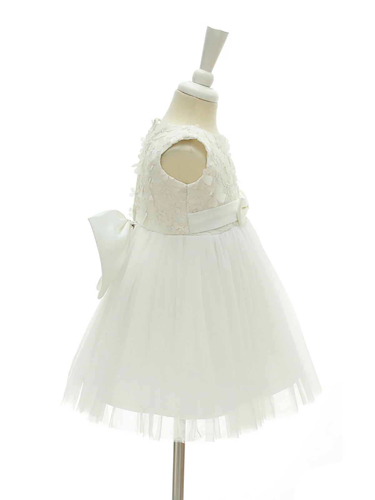 Adeline white tulle dress for girls with floral appliques, lace bodice, bow at waist, knee-length.