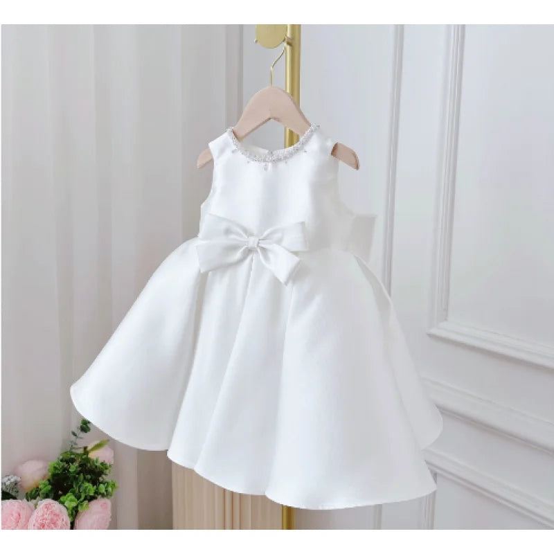 Patience Marie elegant beaded knee-length satin dress for girls, sleeveless with bow at the waist.
