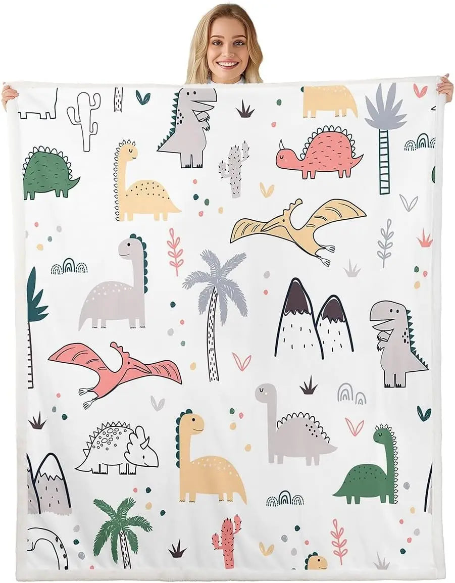 Smiling person holds Jungle Rumble double-sided children's blanket with colorful dinosaur print.