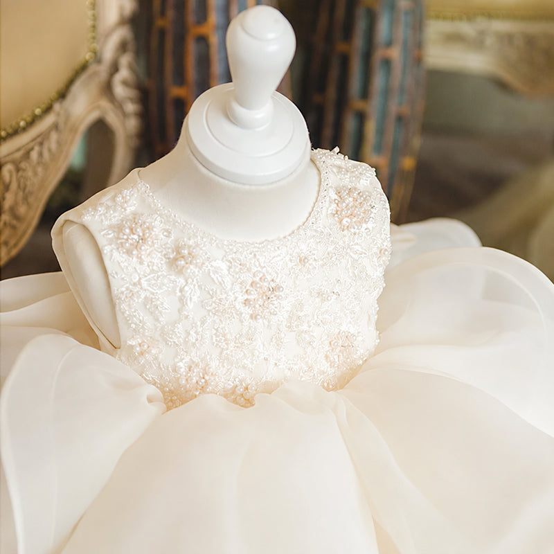 White dress on a mannequin with 'AMOZAE' branding in the background