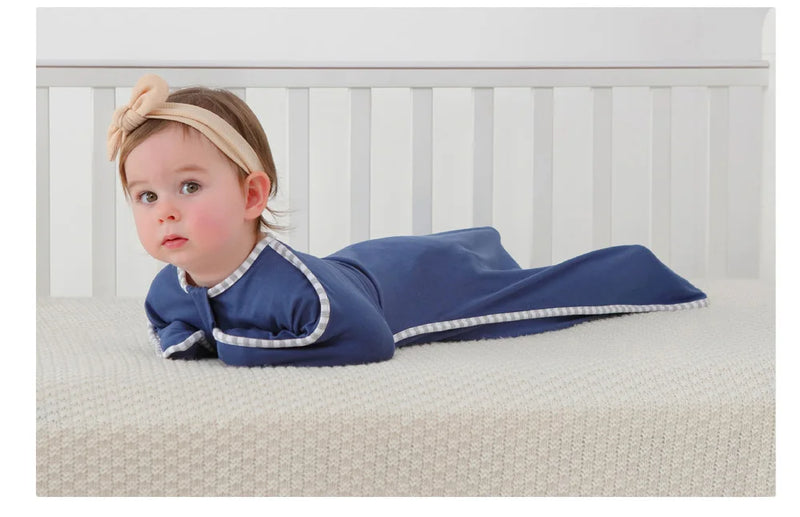 Detailed view of baby enjoying a cozy nap in a navy Cozy Cotton Anti-Kick Calming Baby Sleeping Sack.