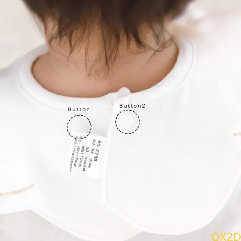 White waterproof baby bib back with snap closure buttons. Cotton embroidered bibs set for boys and girls.