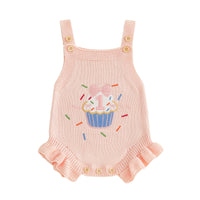 Pink knit baby romper overalls with cupcake embroidery, bow, leg buttons, sleeveless straps, frilled cuffs