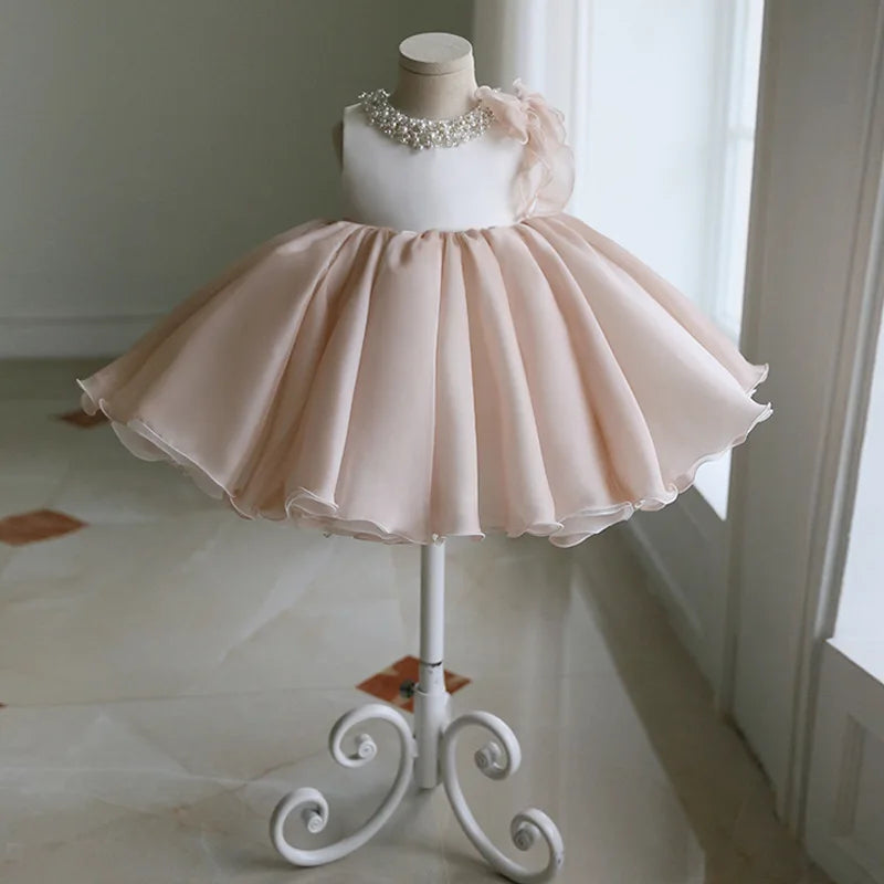 Gwendolyn Tulle Special Occasion Dress - Chic Beige displayed on a dress stand, featuring a flared layered skirt and elegant design for little girls aged 4 to 6.