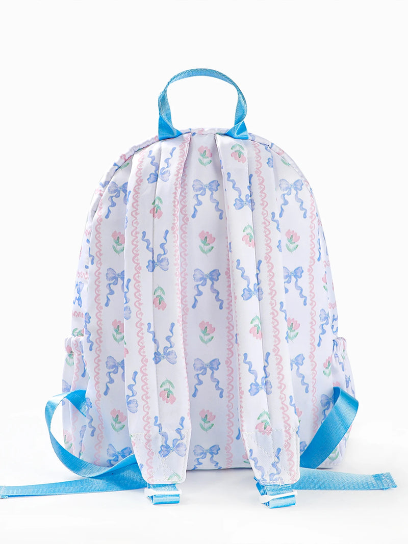 Close-up of Flowers & Bows Floral Printed Backpack featuring stylish ruffled accents and comfortable soft handle, ideal for carrying on school days.