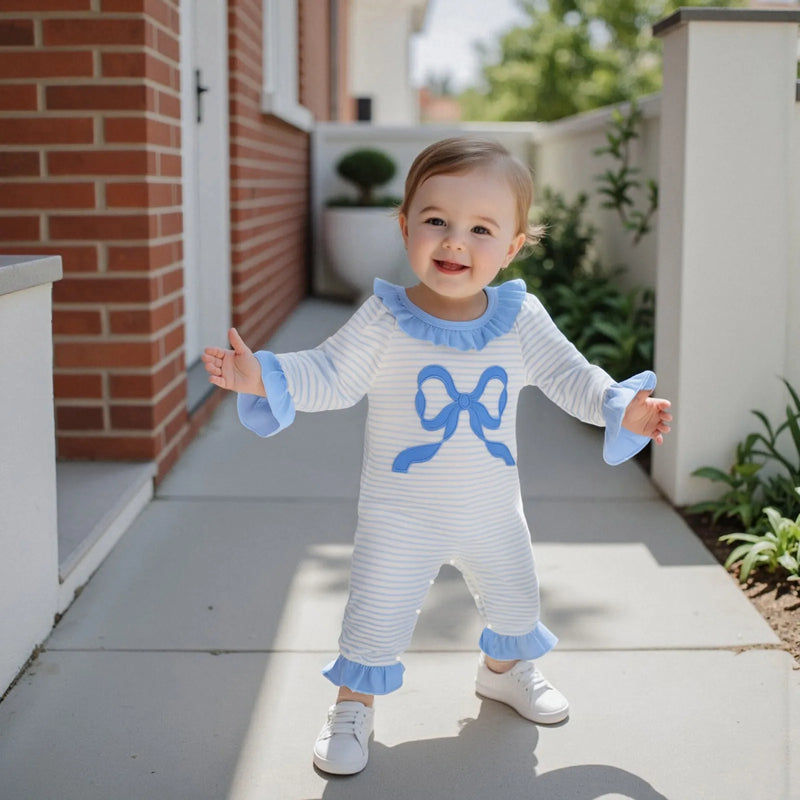 Child joyfully modeling the Little Bow Peep adorable long sleeve baby romper, showcasing comfort and fun in a playful outdoor setting.