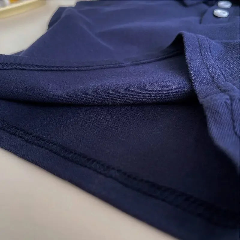 Detail shot of the navy polo shirt from the Preppy 'Daron' 2 PC Kids Khaki Shorts Set, highlighting its quality fabric and stitching for active kids.