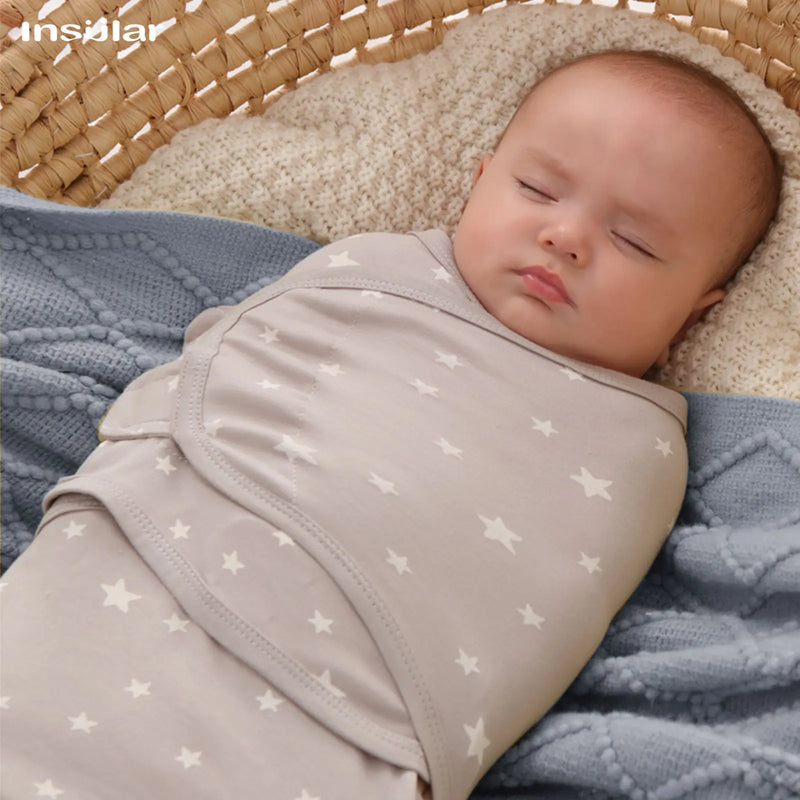 Soothing Baby Swaddle Bags for Babies - 3 Piece Set with a baby nestled in a star-patterned swaddle bag. Trendy baby swaddle bags offer style and comfort.