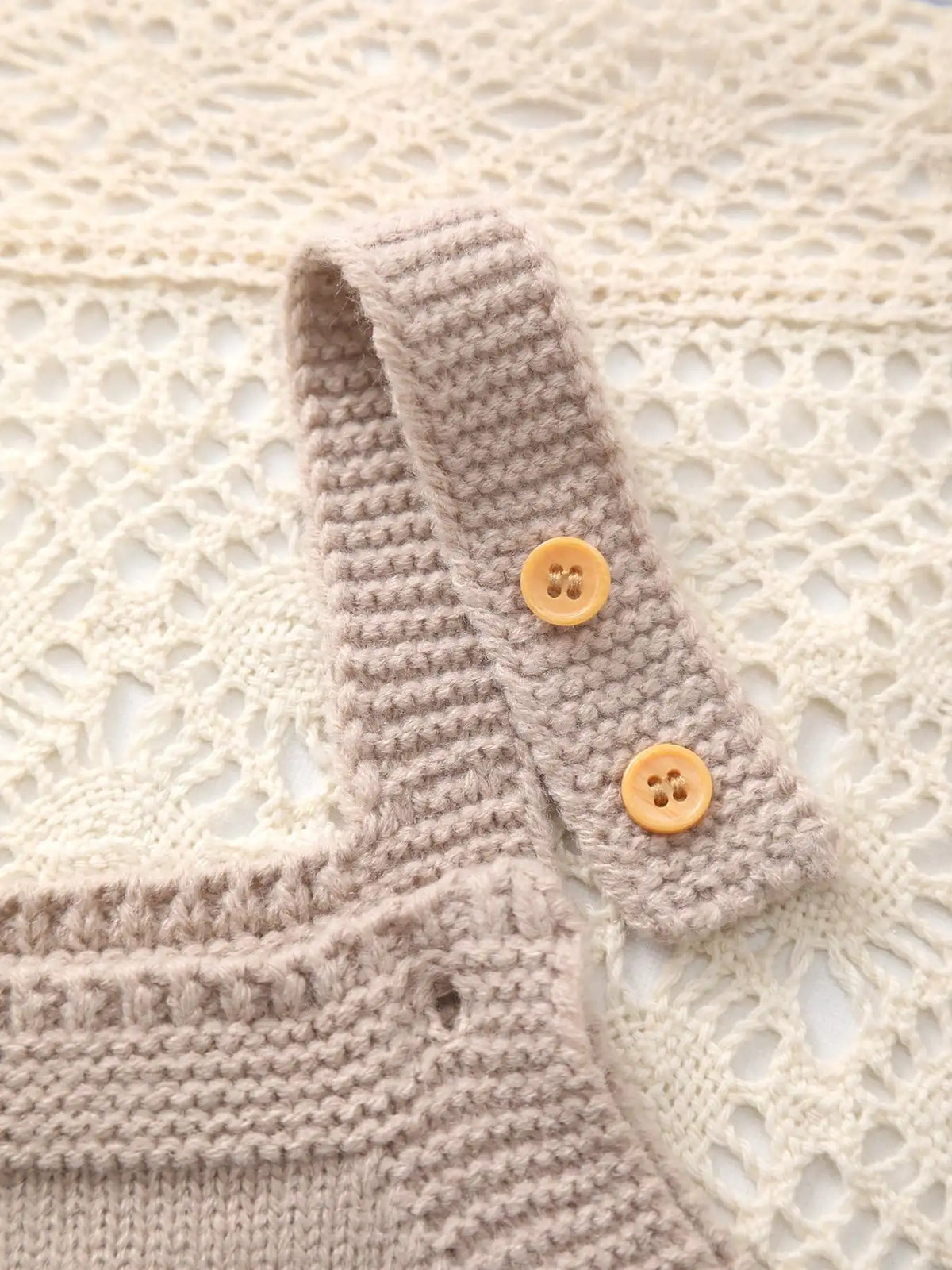 Khaki knitted romper overalls for babies with yellow buttons on a strap and ribbed knit detail.