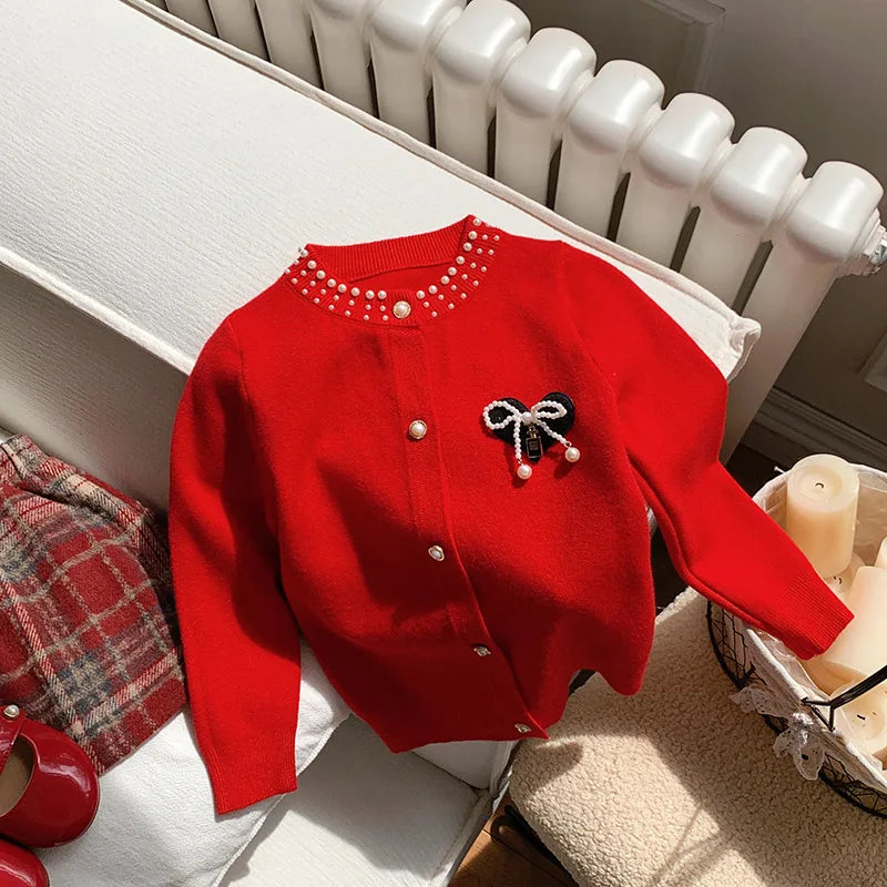 Featuring the vibrant red Bows and Pearls Little Girls Cardigan with faux pearls and bow, showcasing its cozy and stylish appeal for little girls.