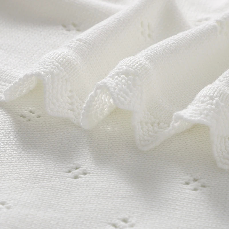 White cotton knit baby baptism and christening blanket with delicate eyelet pattern.