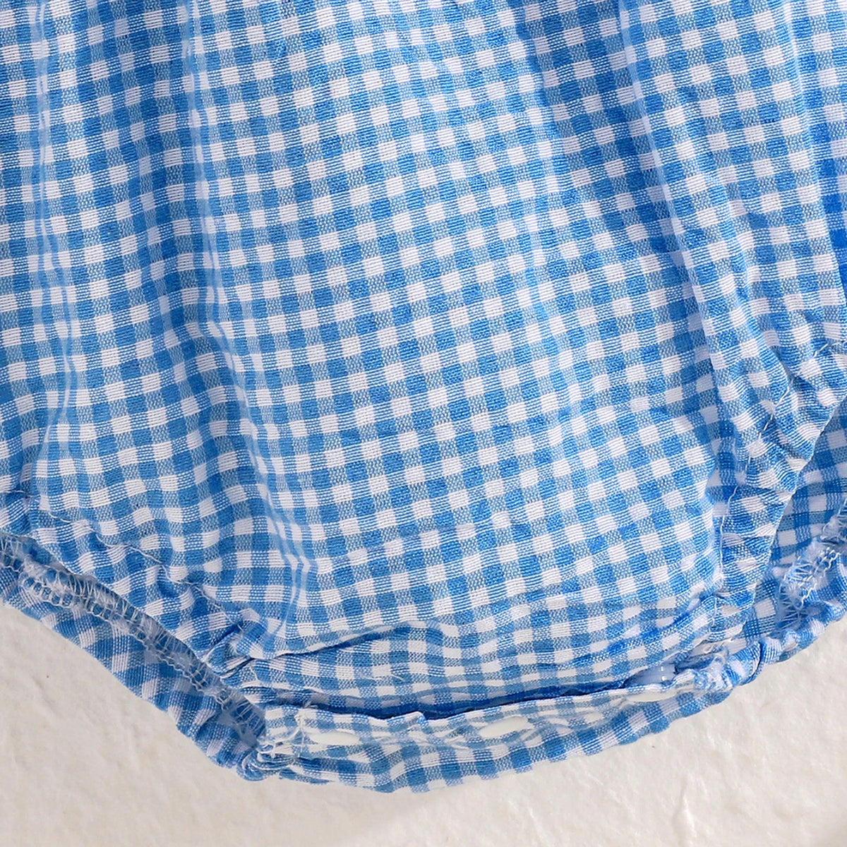 Plaid Duckies Baby Bubble fabric in blue gingham with elastic leg openings.