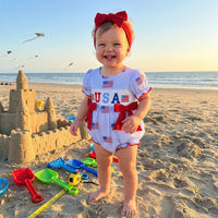 'Anna' American Flag Seersucker Romper with Adorable Bows and Headband - The Palm Beach Baby Estimated 12 - 18 Day Shipping