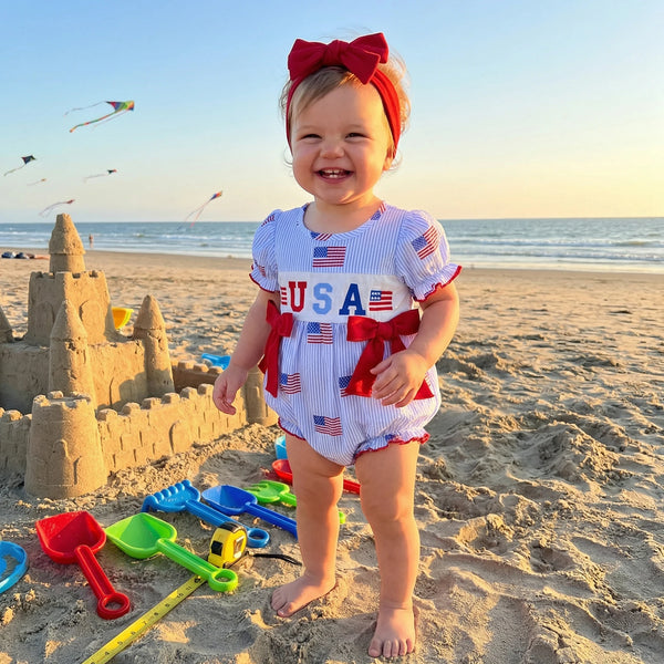 'Anna' American Flag Seersucker Romper with Adorable Bows and Headband - The Palm Beach Baby Estimated 12 - 18 Day Shipping