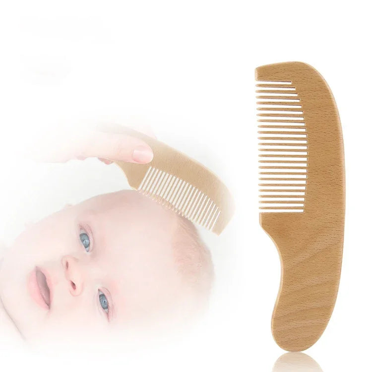 Personalized wooden baby comb, infant grooming accessory shown with baby.