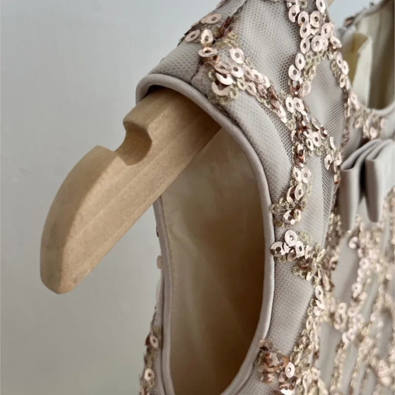 Detail view of the luxurious sequined fabric on the Isabella Elegant Sequined Dress for Little Girls, showcasing the quality craftsmanship.