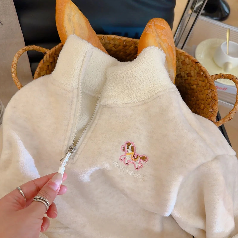 Cream children's fleece pullover with embroidered horse zipper detail, ideal for cozy autumn and winter wear.