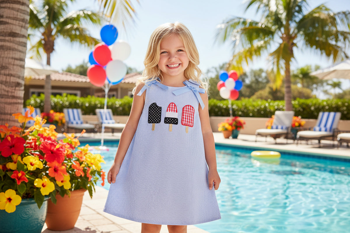 Children's dress with ice cream appliqués on a white background