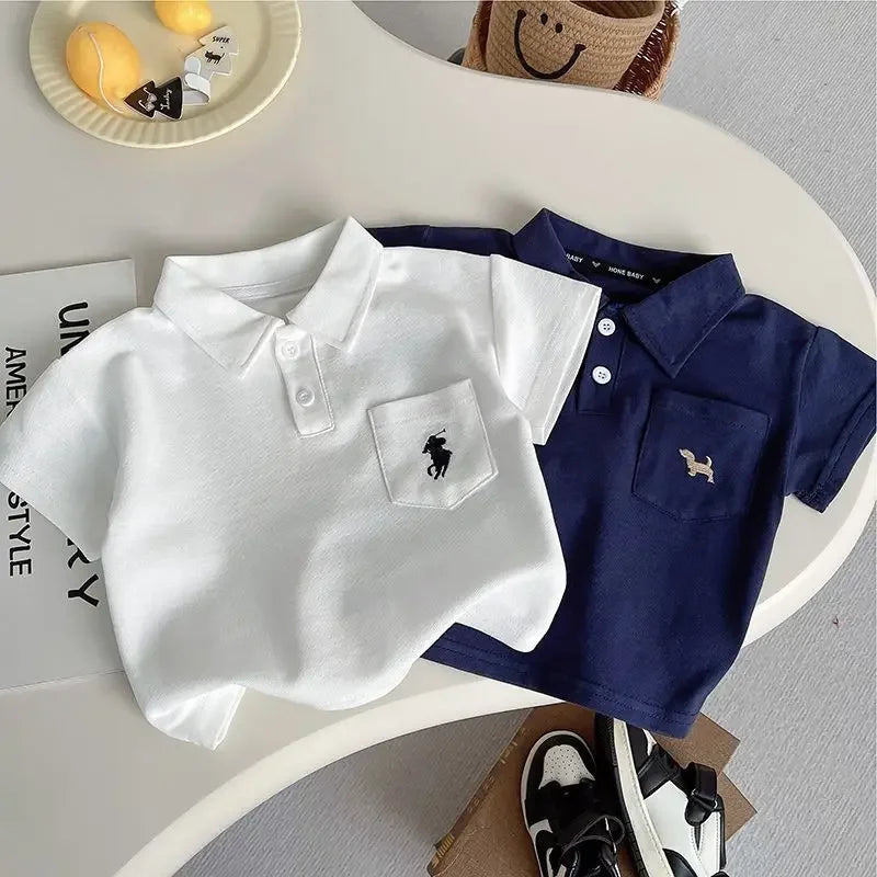 A display of the Preppy 'Daron' 2 PC Kids Khaki Shorts Set, featuring both navy and white polo shirts alongside comfortable khaki shorts.