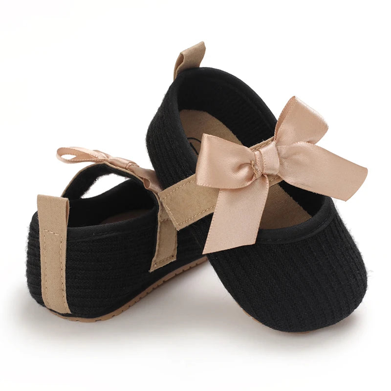 Baby Jane Satin Bow Baby Shoes in black, designed with a charming satin bow and cushioned for comfort.