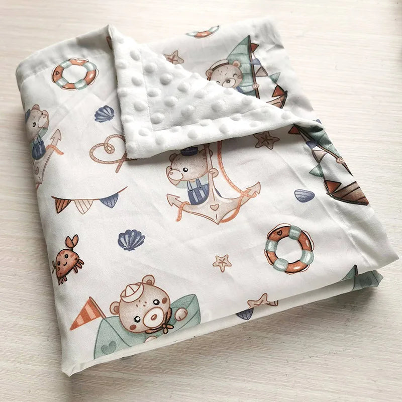 Two-sided children's minky blanket with cute nautical prints and raised dot texture.