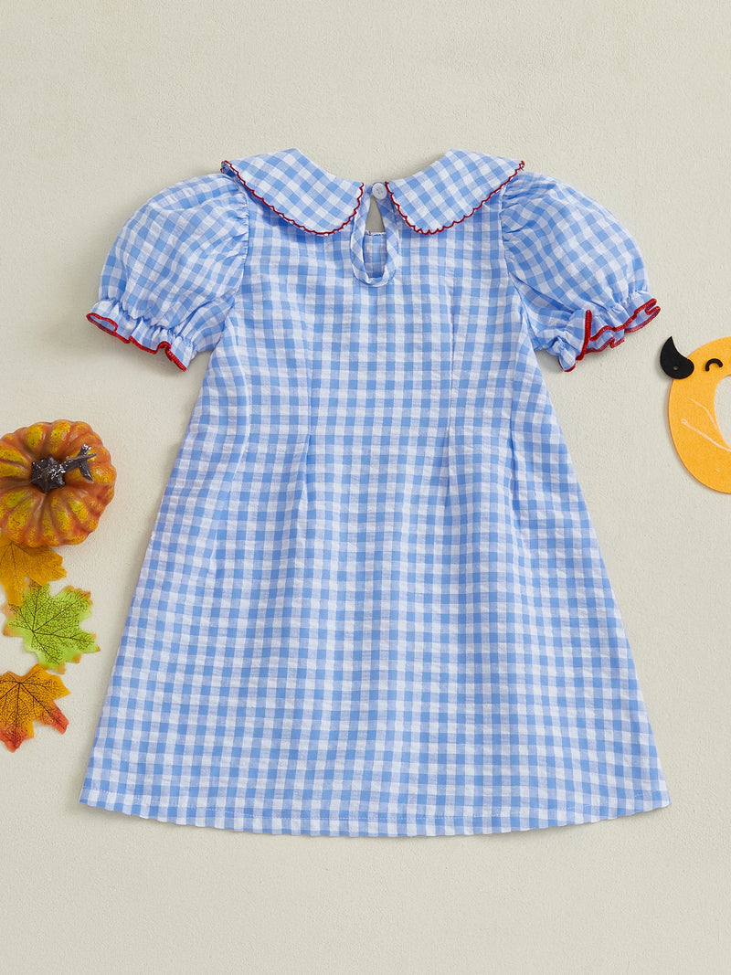 Back view of the Adorable Pumpkins and Checks Girls Dress displaying the lovely puff sleeves and blue gingham pattern, ideal for fall festivities.