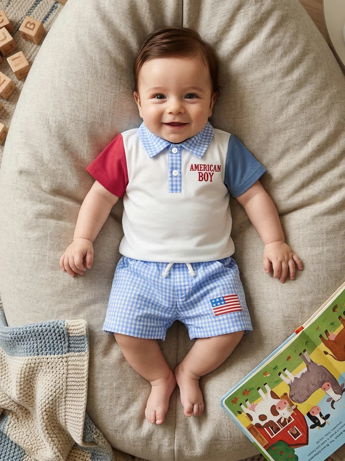 Baby wearing patriotic American Boy polo shirt with blue check collar and light blue gingham shorts with American flag.