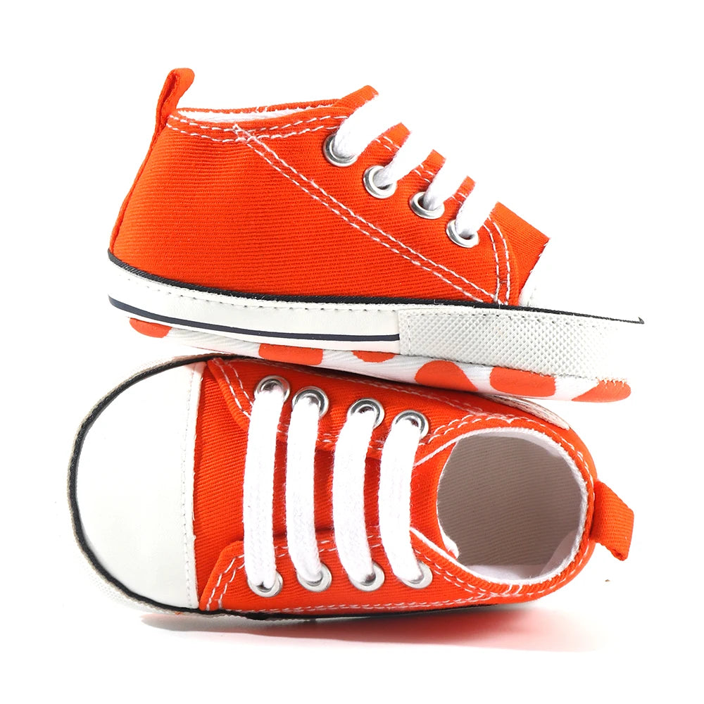Baby's Canvas Soft-Soled Lace-up First Walkers in vibrant orange, perfect for baby's first steps, featuring breathable canvas and secure lace-up closures.