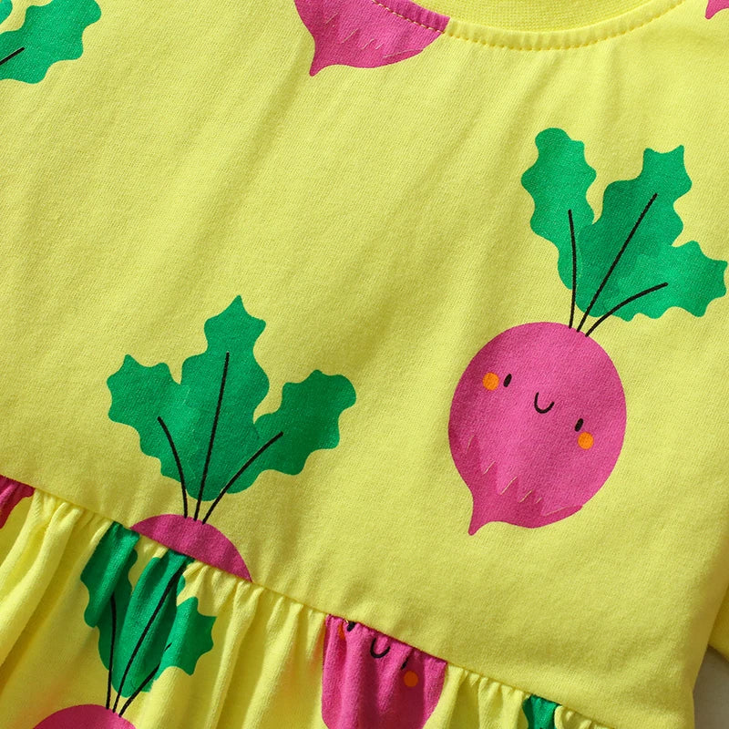Detailed view of the fabric on the Little Cutie fun print dress for girls, highlighting the bright pink radishes on sunny yellow.