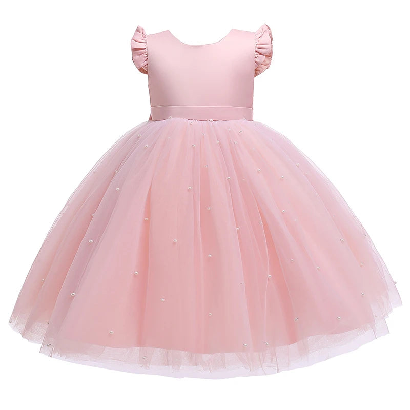A back view of a pink 'Chantelle-Elise' V-Back Occasion Dress on display, emphasizing the large bow and beautiful tulle texture.