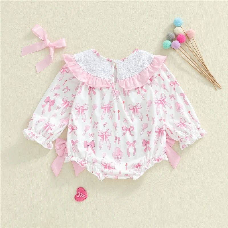 Baby romper with pink bows on a beige background