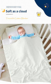Sleeping baby in a crib under a white cotton crocheted cross baptism blanket, 100 x 80 cm, soft knit.