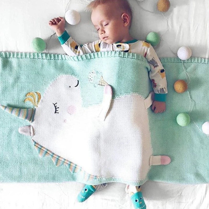 A sleeping baby wrapped in a whimsical unicorn blanket from the 'Sleepy Tight' cute animal blankets for kids.