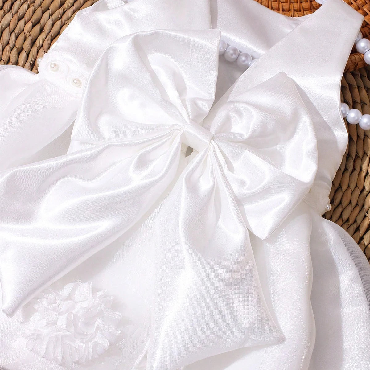 Lara Elegant Infant white two-piece dress with big bow and matching beaded headband.