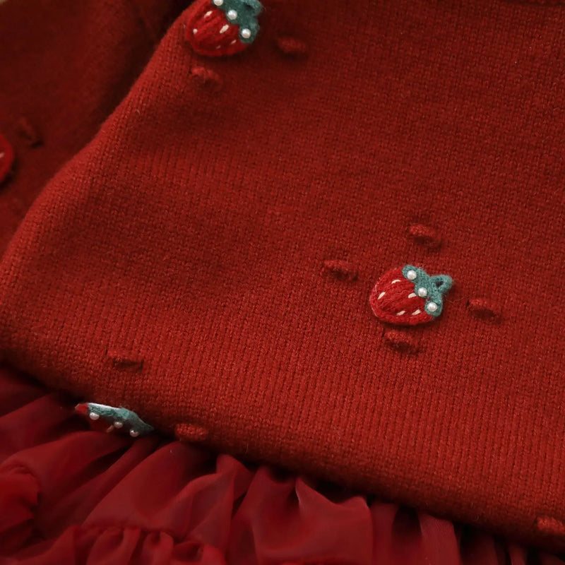 Close-up of the Strawberry Girls Knit Sweater and Tulle Skirt - Deep Red, featuring detailed 3-D strawberry embroidery on the sweater.