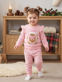 Toddler girl wearing pink and white striped waffle knit Christmas outfit with gingerbread baby embroidery pullover and matching pants.