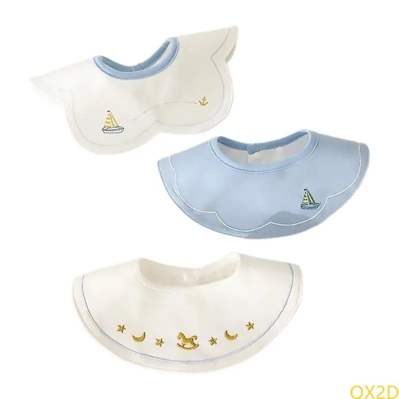 3-piece waterproof baby bib set with embroidered sailboats, anchor, and gold rocking horse on white and blue cotton.