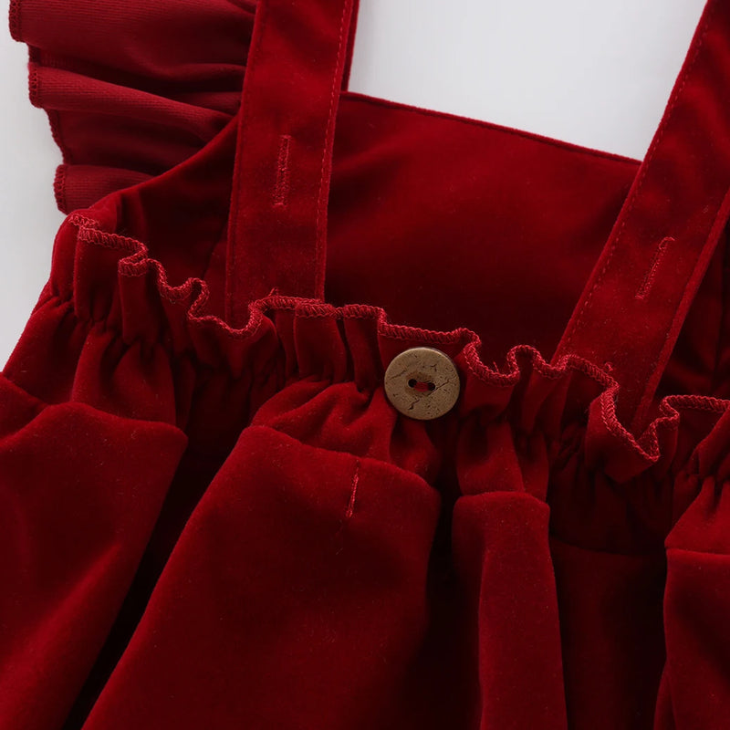 Detail of the wooden button on the Little Sofie Velvet Frilly Bubble, showcasing functional design elements that enhance this delightful frilly bubble romper for infants.