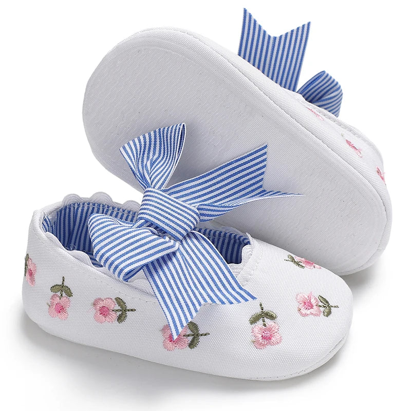 Girls' Mary Jane Soft Cloth Sole Flats Bow Detail in white with embroidered flowers and striped bow.