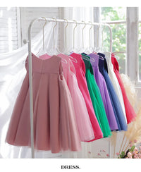 Sari-Elle Elegant Party Dress With Large Bow in 8 colors on a rack for girls aged 4–6; A-line dresses.