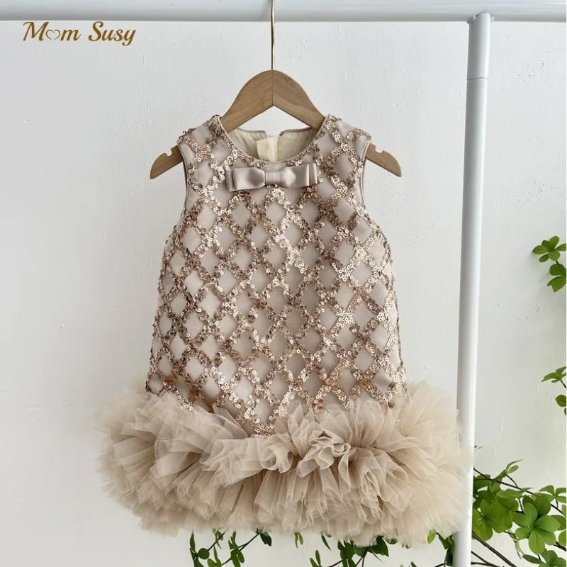 Isabella Elegant Sequined Dress for Little Girls showcases a chic beige design with sequined accents and a ruffled tulle hem, highlighting its elegance.
