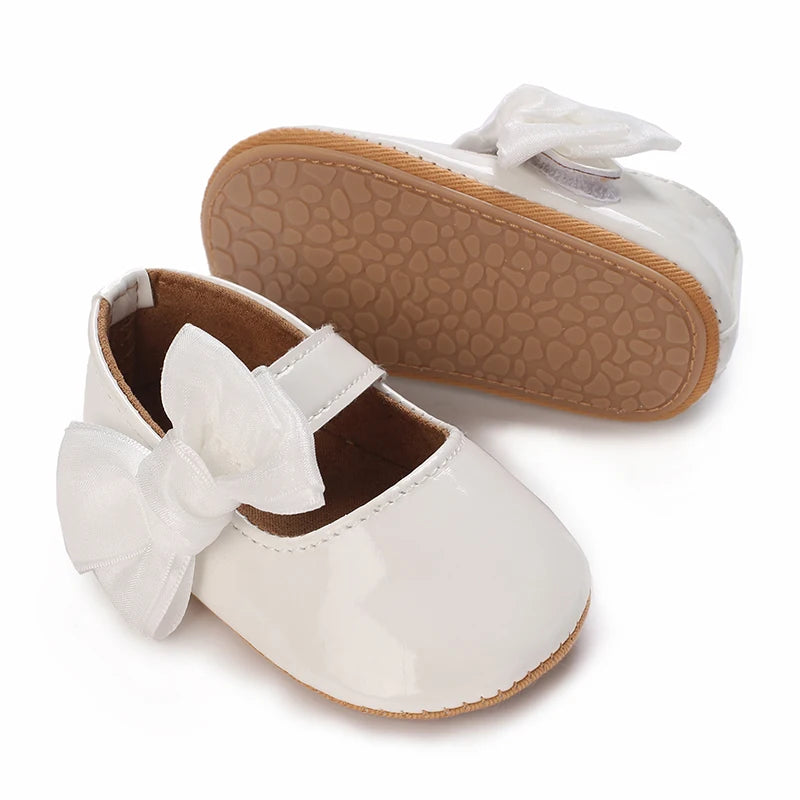 Serena Bow First Walker Shoes - Elegant white Toddler shoes showcasing a butterfly bow, combining safety and style for baby's first steps.