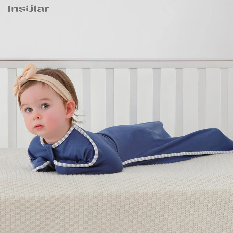 Baby enjoying tummy time in a cozy navy Cozy Cotton Anti-Kick Calming Baby Sleeping Sack, safe and comfortable.