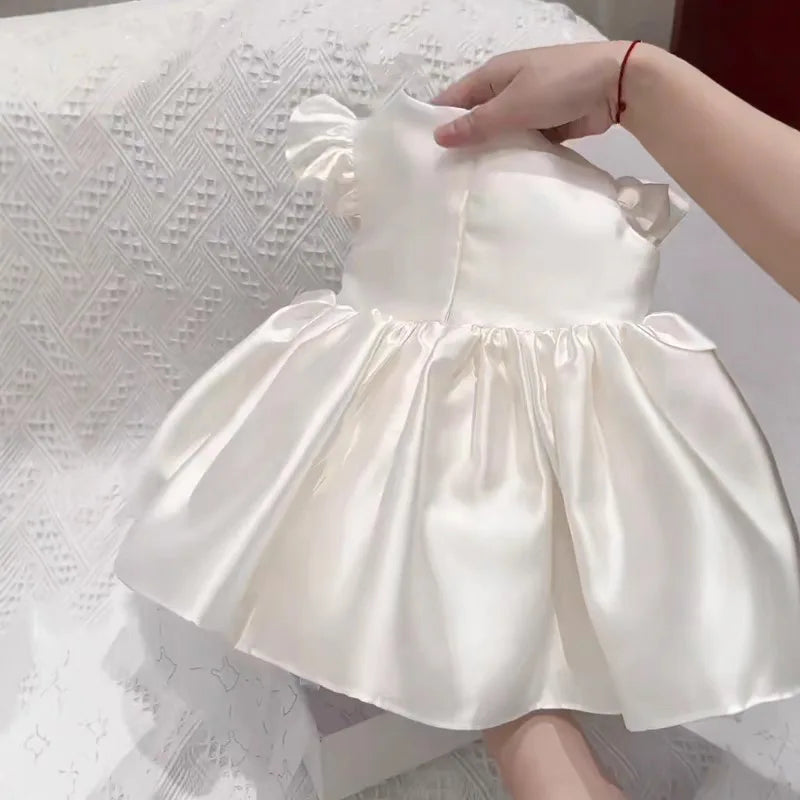 Astrid satin flutter sleeve princess dress for little girls, white satin with zippered back and full ruched skirt.