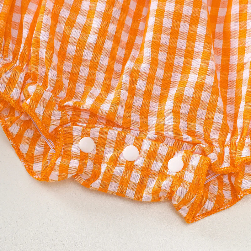 Bottom view of the Gingham Cutie Baby Pumpkin Romper, showing snap closures for easy diaper changes.