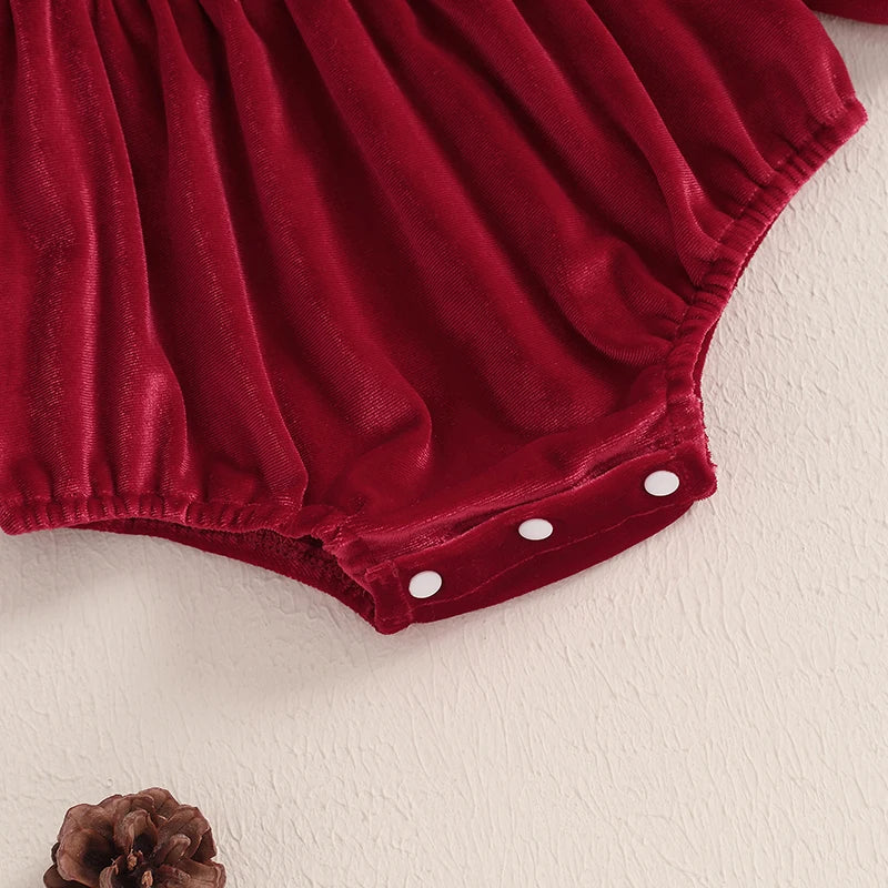 Close-up of the snap closure at the bottom of the deep red Velvet and Frills Holiday Baby Bubble Set, designed for easy diaper changes.
