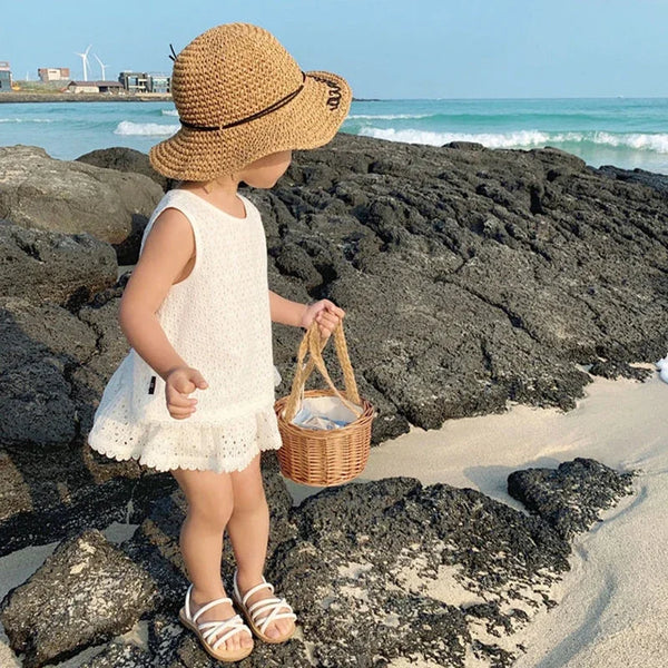 Summer and Lace 2 Piece Little Girls Skort and Top Set: white sleeveless outfit on a beach girl with straw hat.