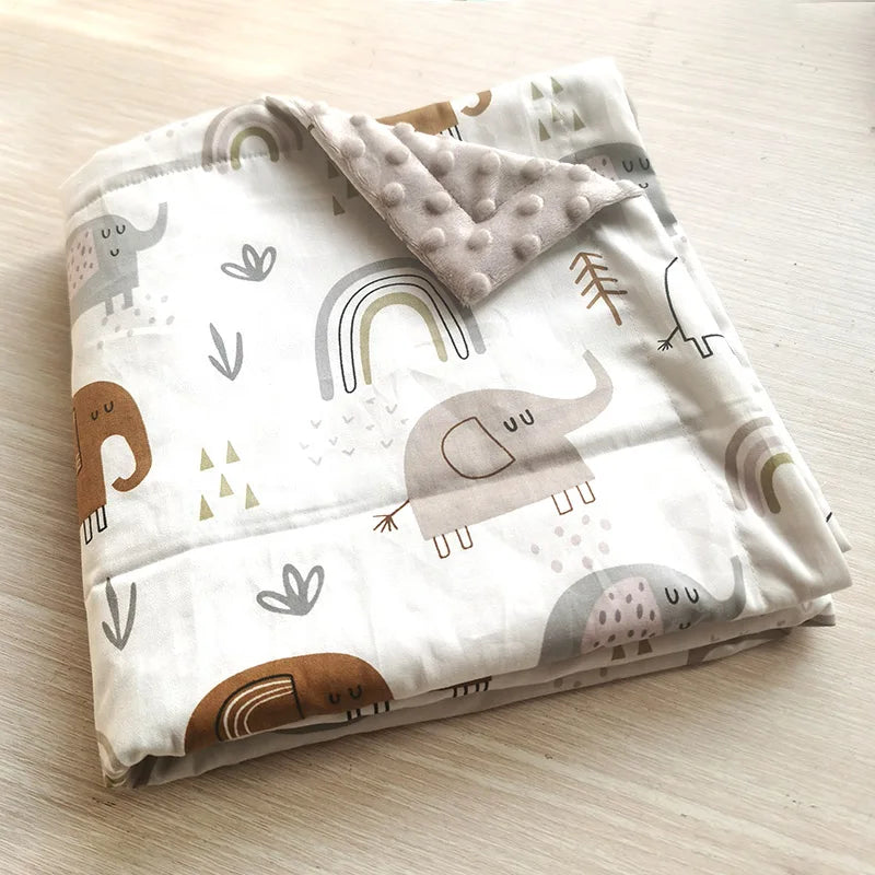 Two-sided children's Minky blanket with cute elephants and rainbow prints and raised dots.