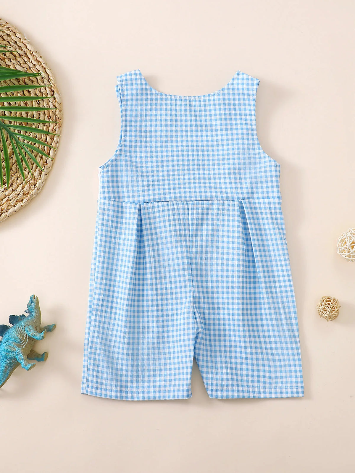 Back view of blue and white check sleeveless baby romper with round neckline and short legs for toddlers.